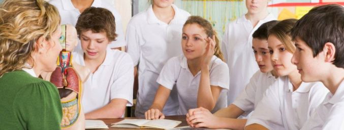 Schoolchildren and teacher in science class