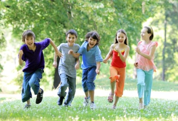 Children running in the green park.