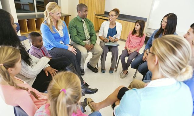 Elementary school discussion meeting with teachers parents and students